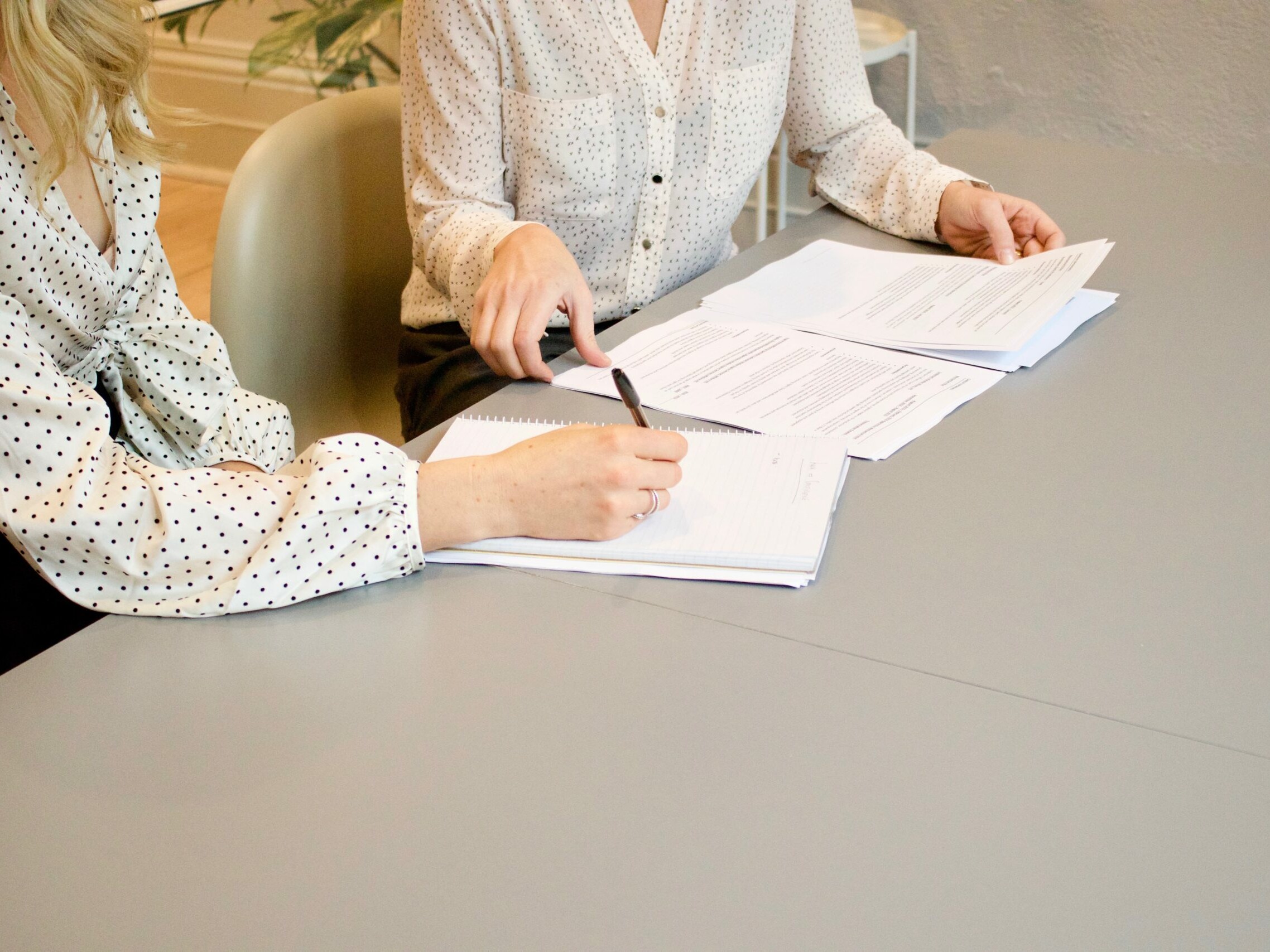 women looking at paperwork on desk