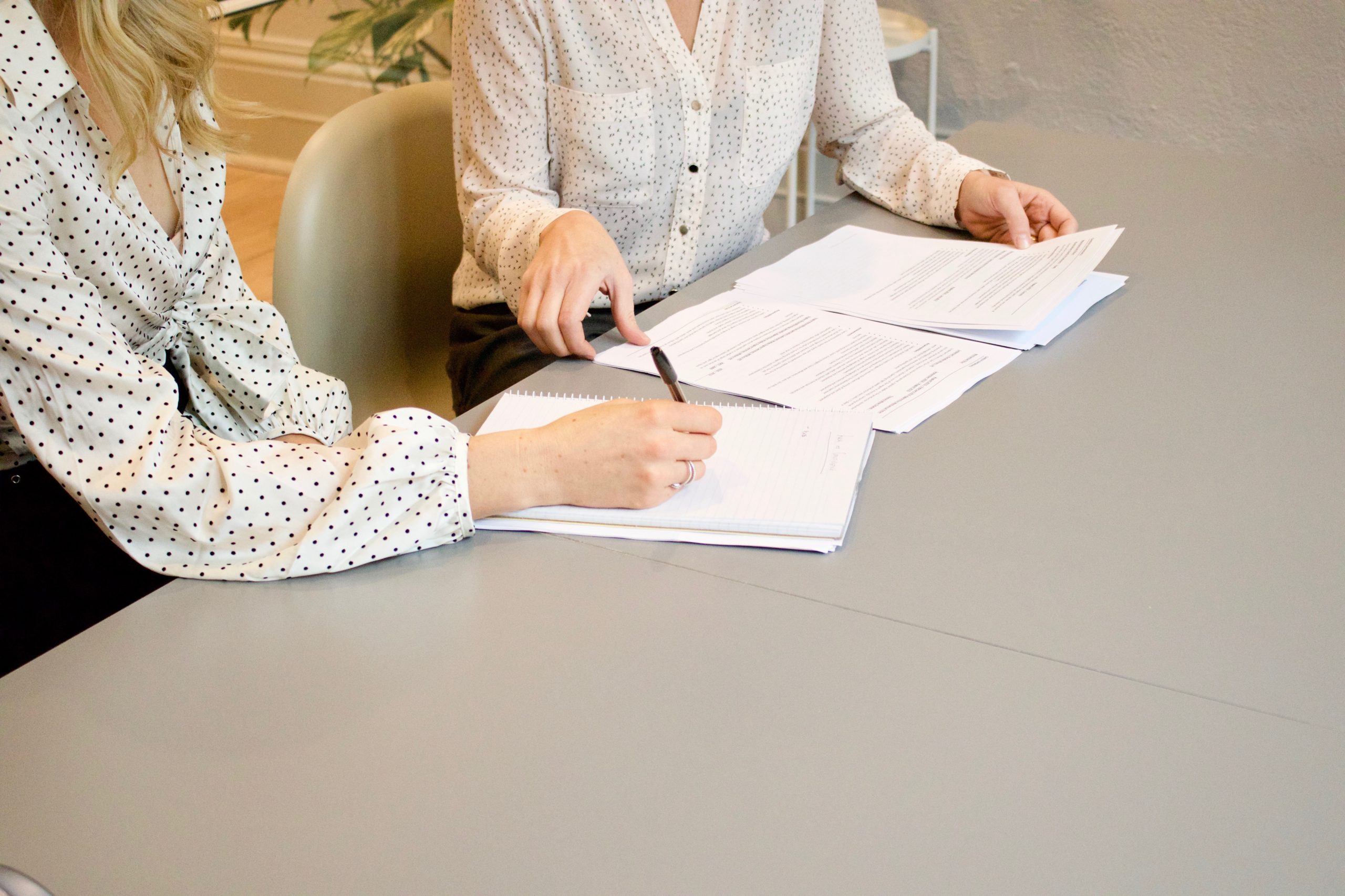 women looking at paperwork on desk