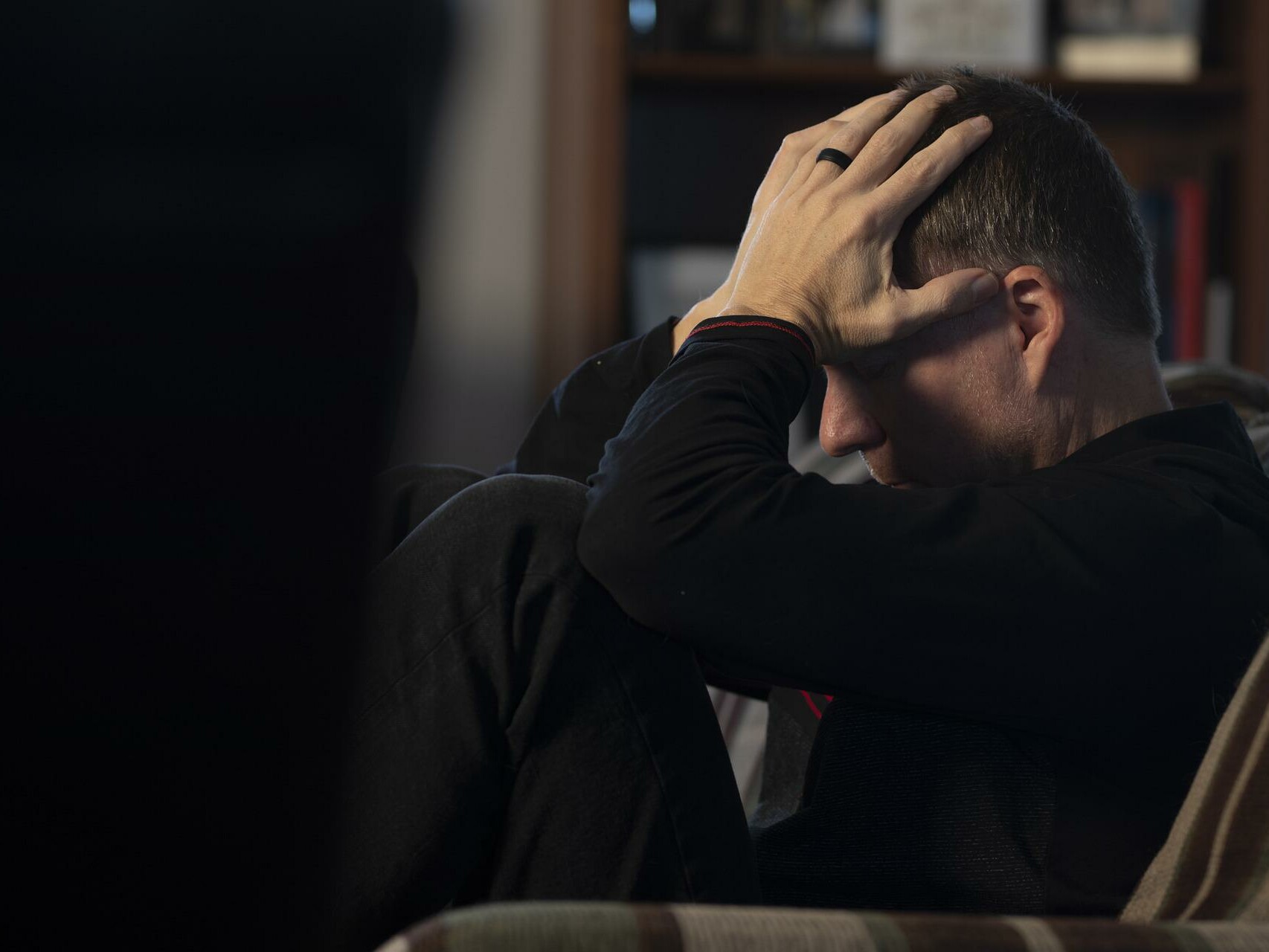 man with head in hands feeling depressed